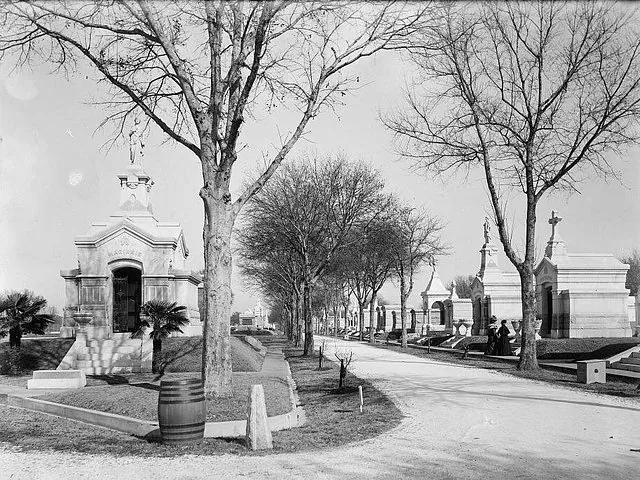 Historic photograph of grand mausoleums lining a path in Metairie Cemetery.